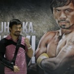 
              Filipino boxer and Congressman Manny Pacquiao poses for the media following a news conference upon arrival Wednesday, May 13, 2015 at the Ninoy Aquino International Airport at suburban Pasay city south of Manila, Philippines. Pacquiao, who was defeated by Floyd Mayweather Jr. in their welterweight fight in Las Vegas May 2, faces lawsuits allegedly for not disclosing his shoulder injury before the fight. (AP Photo/Bullit Marquez)
            