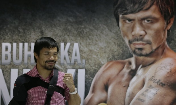 Filipino boxer and Congressman Manny Pacquiao poses for the media following a news conference upon ...