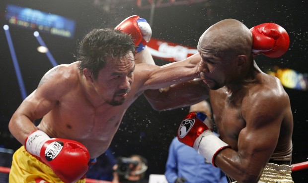 FILE – In this May 2, 2015 file photo, Manny Pacquiao, left, from the Philippines, trades blo...