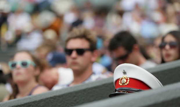 The top of a military steward’s hat in view, at the All England Lawn Tennis Championships in ...