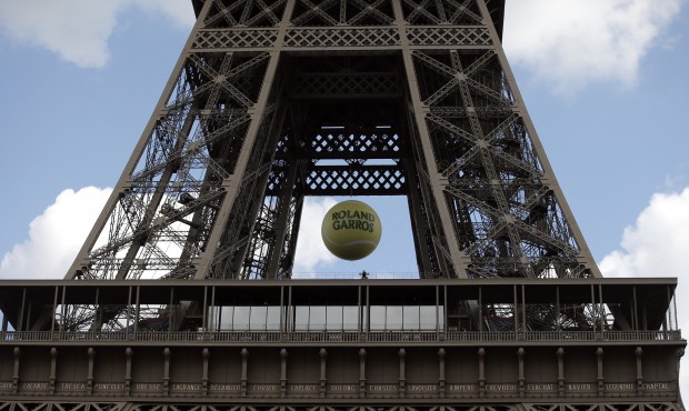 A giant tennis ball is hung under the second floor of the Eiffel Tower in Paris, Saturday, May 23, ...