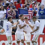 
              United States' Omar Gonzalez, second from left, celebrates his goal with teammates Ventura Alvarado, left, Aron Johannsson (9) and Clint Dempsey during the first half of a CONCACAF Gold Cup soccer quarterfinal against Cuba, Saturday, July 18, 2015, in Baltimore. (AP Photo/Patrick Semansky)
            