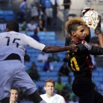 
              Cuba goalkeeper Diosvelis Guerra, right, catches a shot as Guatemala’s Deniss Lopez, left, closes in during the first half of a CONCACAF Gold Cup soccer match in Charlotte, N.C., Wednesday, July 15, 2015. (AP Photo/Chuck Burton)
            