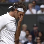 
              Roger Federer of Switzerland touches his face during the men's singles final against Novak Djokovic of Serbia at the All England Lawn Tennis Championships in Wimbledon, London, Sunday July 12, 2015. (Toby Melville/Pool Photo via AP)
            