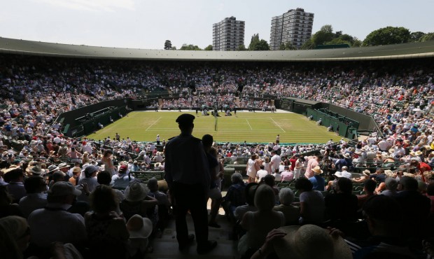 Spectators on No. 1 Court watch the match between Milos Raonic of Canada and Tommy Haas of Germany ...