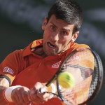 
              Serbia's Novak Djokovic returns in the quarterfinal match of the French Open tennis tournament against Spain's Rafael Nadal at the Roland Garros stadium, in Paris, France, Wednesday, June 3, 2015. (AP Photo/David Vincent)
            