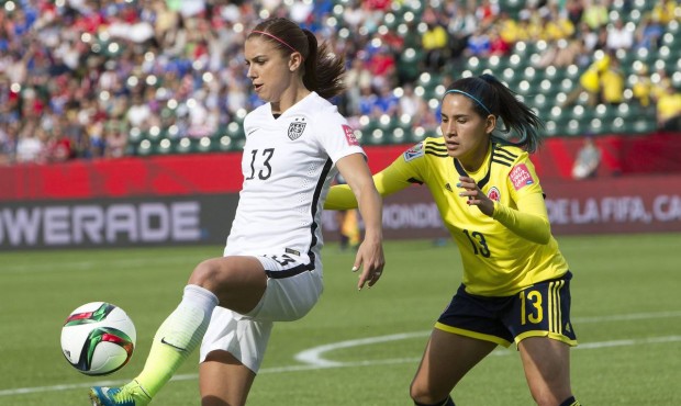 United States’ Alex Morgan (13) kicks the ball in front ofColombia’s Angela Clavijo (13...