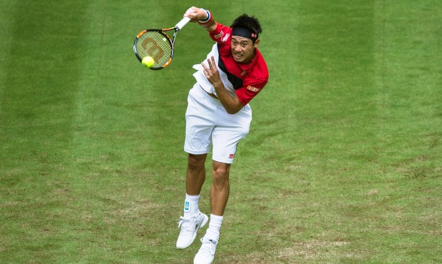 Kei Nishikori of Japan returns the ball to Austria’s Dominic Thiem during their first round m...