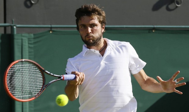 Gilles Simon of Franc returns a ball to Tomas Berdych of the Czech Republic during their singles ma...