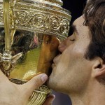
              FILE - In this July 8, 2012 file photo, Roger Federer, of Switzerland, kisses the trophy after defeating Andy Murray, of Britain in the men's singles final at the All England Lawn Tennis Championships at Wimbledon, London. When Pete Sampras lost to Federer early on in the 2001 tournament, few, if any, would have thought that the young Swiss would end up equaling Sampras' haul of seven Wimbledon titles. His victory over Britain’s Murray in 2012 equaled Sampras’ record. Though he’s now 33, Federe has a shot at making it eight this year. Despite his success over the years at Wimbledon, Federer’s most famous final remains the 2008 contest against Rafael Nadal, when he lost over five sets.  (AP Photo/Kirsty Wigglesworth, File)
            