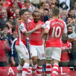 
              Arsenal's Theo Walcott, center, celebrates scoring his side's second goal against West Bromwich Albion with teammates Hector Bellerin, left, and Jack Wilshere during the English Premier League soccer match at the Emirates Stadium, London, Sunday May 24, 2015. (Dominic Lipinski/PA via AP) UNITED KINGDOM OUT  NO SALES  NO ARCHIVE
            