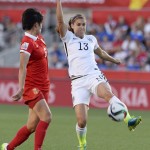 
              United States'Alex Morgan (13) controls the ball as China's Li Dongna (6) defends during the first half quarterfinal match in the FIFA Women's World Cup soccer tournament, Friday, June 26, 2015, in Ottawa, Ontario, Canada. (Adrian Wyld/The Canadian Press via AP)
            