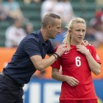 
              England's head coach Mark Sampson, left, and Laura Bassett (6) discuss a corner kick against Germany during second-half action of the FIFA Women's World Cup soccer third-place match in Edmonton, Alberta, Canada, on Saturday, July 4, 2015. (Jason Franson/The Canadian Press via AP) MANDATORY CREDIT
            
