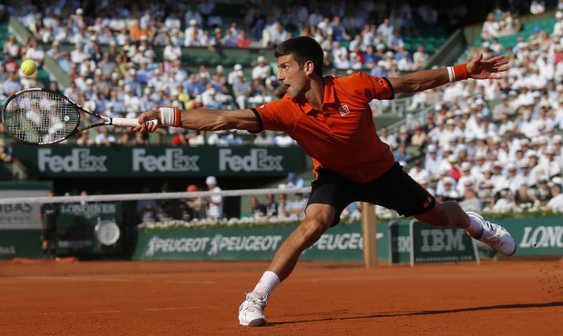 Serbia’s Novak Djokovic stretches to return the ball to Britain’s Andy Murray, right, d...