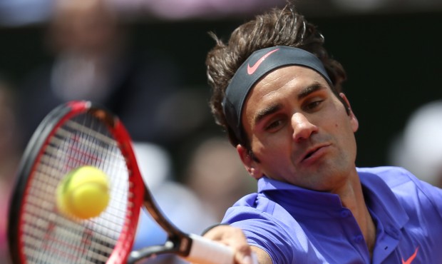 Switzerland’s Roger Federer returns the ball to France’s Gael Monfils during their four...
