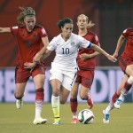 
              United States' Carli Lloyd (10) breaks away from Germany's Melanie Leupolz, left, Lena Goessling and Annike Krahn, right, during the second half of a semifinal in the Women's World Cup soccer tournament, Tuesday, June 30, 2015, in Montreal, Canada. The United States won 2-0. (Ryan Remiorz/The Canadian Press via AP)
            