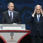 
              FIFA President Sepp Blatter, right, adjusts his glasses during a speech by Russian President Vladimir Putin during the preliminary draw for the 2018 soccer World Cup in Konstantin Palace in St. Petersburg, Russia, Saturday, July 25, 2015. (AP Photo/Ivan Sekretarev)
            