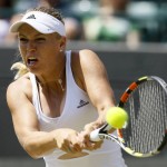 
              Caroline Wozniacki of Denmark returns a ball to Camila Giorgi of Italy during their singles match at the All England Lawn Tennis Championships in Wimbledon, London, Saturday July 4, 2015. (AP Photo/Kirsty Wigglesworth)
            