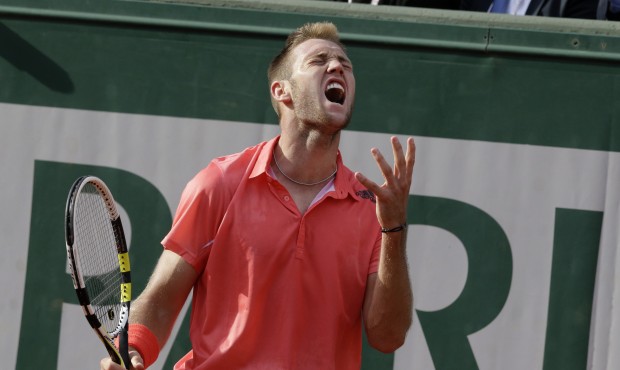 Jack Sock of the U.S. screams after missing a shot in the fourth round match of the French Open ten...