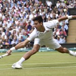 
              Novak Djokovic of Serbia returns a ball to Roger Federer of Switzerland during the men's singles final at the All England Lawn Tennis Championships in Wimbledon, London, Sunday July 12, 2015. (Toby Melville/Pool Photo via AP)
            