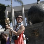 
              A tourist poses for a photo with a replica of a FIFA trophy at the Maracana Stadium, in Rio de Janeiro, Brazil, Wednesday, May 27, 2015. Brazilian Jose Maria Marin, the former president of the Brazilian Football Confederation, was among seven high-ranking soccer officials arrested Wednesday in Zurich on U.S. charges of corruption.  (AP Photo/Silvia Izquierdo)
            