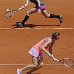 
              Bethanie Mattek-Sands of the U.S., top, and Lucie Safarova of the Czech Republic return in the women's doubles final of the French Open tennis tournament against Casey Dellacqua of Australia and Yaroslava Shvedova of Kazakhstan at the Roland Garros stadium, in Paris, France, Sunday, June 7, 2015. (AP Photo/Thibault Camus)
            