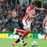 
              Stoke City's Jonathan Walters, right, is tackled by Liverpool's Lucas during the English Premier League soccer match between Stoke City and Liverpool at the Britannia Stadium, Stoke on Trent, England, Sunday, May 24, 2015. (AP Photo/Rui Vieira)
            