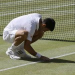 
              Novak Djokovic of Serbia touches the grass after winning the singles match against Richard Gasquet of France after their men's singles semifinal match at the All England Lawn Tennis Championships in Wimbledon, London, Friday July 10, 2015. Djokovic won 7-6, 6-4, 6-4.  (AP Photo/Kirsty Wigglesworth)
            