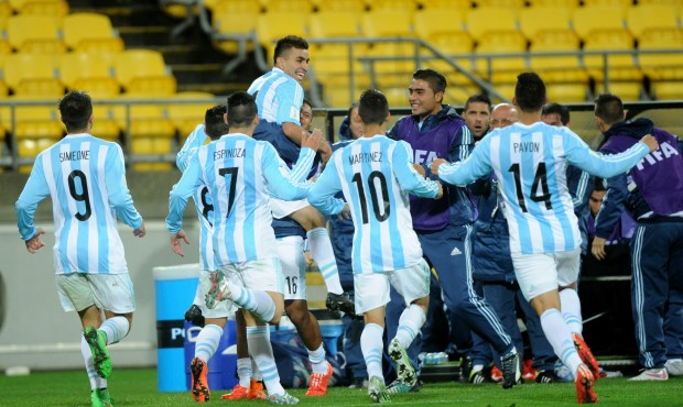 Argentina’s Angel Correa, top, is congratulated by teammates after scoring goal against Panam...
