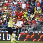 
              Manchester United's Morgan Schneiderlin (28) heads in a goal past Club America's Javier Guemez, left, in the first half of an international friendly soccer match, Friday, July 17, 2015, in Seattle. (AP Photo/Ted S. Warren)
            