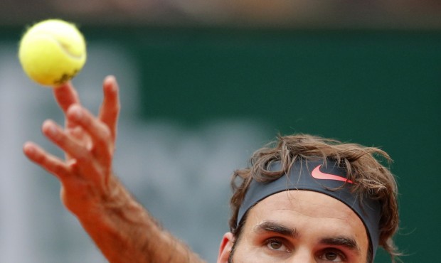 Switzerland’s Roger Federer serves the ball to France’s Gael Monfils during their fourt...