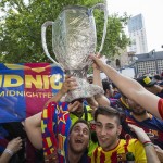 
              Spanish soccer fans of FC Barcelona celebrate with a self-made trophy before the soccer Champions League final between Juventus Turin and FC Barcelona in Berlin, Germany, Saturday, June 6, 2015. (AP Photo/Gero Breloer)
            