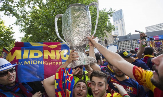 Spanish soccer fans of FC Barcelona celebrate with a self-made trophy before the soccer Champions L...