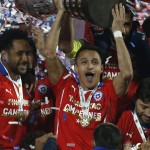 
              Chile's Alexis Sanchez lifts the trophy after winning the Copa America final soccer match against Argentina at the National Stadium in Santiago, Chile, Saturday, July 4, 2015. Chile defeated Argentina 4-1 in a penalty shoot out after the game ended in a 0-0 draw. (AP Photo/Luis Hidalgo)
            
