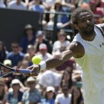 
              Dustin Brown of Germany returns the ball during his singles tennis match against Viktor Troicki of Serbia at the All England Lawn Tennis Championships in Wimbledon, London, Saturday July 4, 2015. (AP Photo/Pavel Golovkin)
            