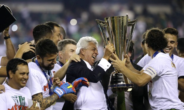 Justino Compean, center, president of Mexico’s football federation, celebrates with Mexico pl...