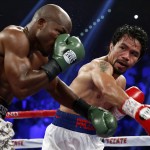 
              ADVANCE FOR WEEKEND EDITIONS, APRIL 25-26 - FILE - In this April 12, 2014 file,photo, Manny Pacquiao, right, of the Philippines, trades blows with Timothy Bradley, in their WBO welterweight title boxing match in Las Vegas. This is not Hagler-Hearns or Tyson vs. Anyone. Floyd Mayweather Jr. is the greatest defensive boxer in history, and Manny Pacquiao hasn't shown knockout power in a while. Expect this fight to go to the scorecards. (AP Photo/Isaac Brekken)
            