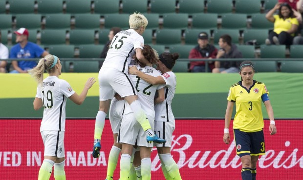 The United States celebrates a goal as Colombia’s Natalia Gaitan (3) walks past during the se...