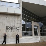 
              Private security guards stand outside the headquarters of sports marketing company Traffic Sports, in Sao Paulo, Brazil, Thursday, May 28, 2015. U.S. officials say Jose Hawilla, the owner of the Brazil-based sports marketing firm, is one of four men who has pleaded guilty in the U.S. soccer corruption investigation involving bribes totaling more than $100 million. (AP Photo/Andre Penner)
            