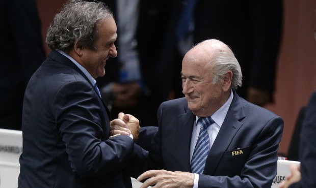 Re-elected FIFA president Sepp Blatter, right, is congratulated by FIFA vice president and UEFA pre...