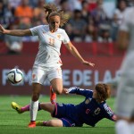 
              Japan's Mizuho Sakaguchi, bottom, kicks the ball away from Netherlands' Lieke Martens during the first half of a round of 16 soccer match at the FIFA Women's World Cup, Tuesday, June 23, 2015, in Vancouver, British Columbia, Canada. (Darryl Dyck/The Canadian Press via AP)
            