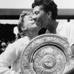 
              FILE - In this July 6, 1957 file photo, Althea Gibson of New York city, holding the large gold plate presented to her as the winner of the Women's Singles Tennis title at the All England Lawn Tennis Championships in Wimbledon, London, is kissed by her opponent, Darlene Hard. Gibson became the first black player, male or female, to win Wimbledon when she defeated fellow American Hard in the final. She ended up with five Grand Slam singles titles, including two Wimbledon crowns, and was twice named The Associated Press’ “Female Athlete of the Year.” Her pioneering didn’t end with tennis. In 1964, Gibson became the first black woman to play in the Ladies Professional Golf Association. (AP Photo, File)
            