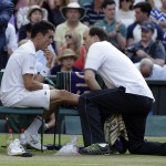 
              Roberto Bautista Agut of Spain receives treatment during the singles match against Roger Federer of Switzerland, at the All England Lawn Tennis Championships in Wimbledon, London, Monday July 6, 2015. (AP Photo/Alastair Grant)
            