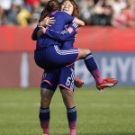 
              Japan's Nahomi Kawasumi jumps into the arms of Mizuho Sakaguchi (6) after the team's 2-1 win over England in a semifinal in the FIFA Women's World Cup soccer tournament, Wednesday, July 1, 2015, in Edmonton, Alberta, Canada. (Jeff McIntosh/The Canadian Press via AP)
            
