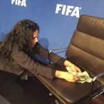 
              A woman collects bank notes after a comedian threw them during a FIFA press conference in Zurich, Switzerland, Monday, July 20, 2015. Sepp Blatter’s news conference at FIFA has been disrupted and delayed by a British comedian’s stunt protest. As Blatter took his seat, performer Simon Brodkin rose from a front-row seat to speak and shower the FIFA president with dollar bills.  (AP Photo/Rob Harris)
            