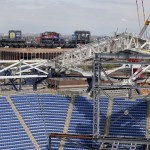 
              Parts of the new roof over Arthur Ashe Stadium are held up by temporary supports as construction continues, Friday, May 1, 2015, in New York. While Wimbledon and the Australian Open already put retractable roofs over their main stadiums, players and fans at the U.S. Open won’t be able to enjoy the final result until the 2016 tournament. (AP Photo/Julie Jacobson)
            
