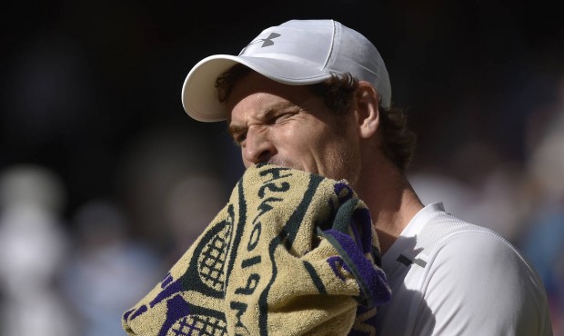 Andy Murray of Britain wipes his face with a towel after losing the 2nd set against Roger Federer o...