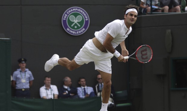 Roger Federer of Switzerland serves to Gilles Simon of France during their singles match at the All...