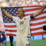 
              United States' Abby Wambach holds up the U.S. flag as she celebrates after the U.S. beat Japan 5-2 in the FIFA Women's World Cup soccer championship in Vancouver, British Columbia, Canada, Sunday, July 5, 2015. (AP Photo/Elaine Thompson)
            