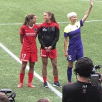 
              CORRECTS FIRST NAME TO TOBIN INSTEAD OF ROBIN - Tobin Heath, Alex Morgan and Megan Rapinoe, from left, are honored before the Portland Thorns’ NWSL soccer match against the Seattle Reign in Portland, Ore., on Wednesday, July 22, 2015. The trio were part of the U.S. team that won the Women’s World Cup this summer. (AP Photo/Anne M. Peterson)
            